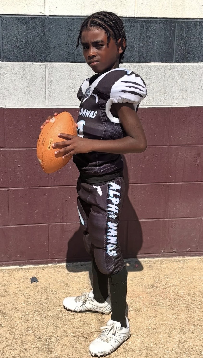 Jace Garcia holding a football in uniform